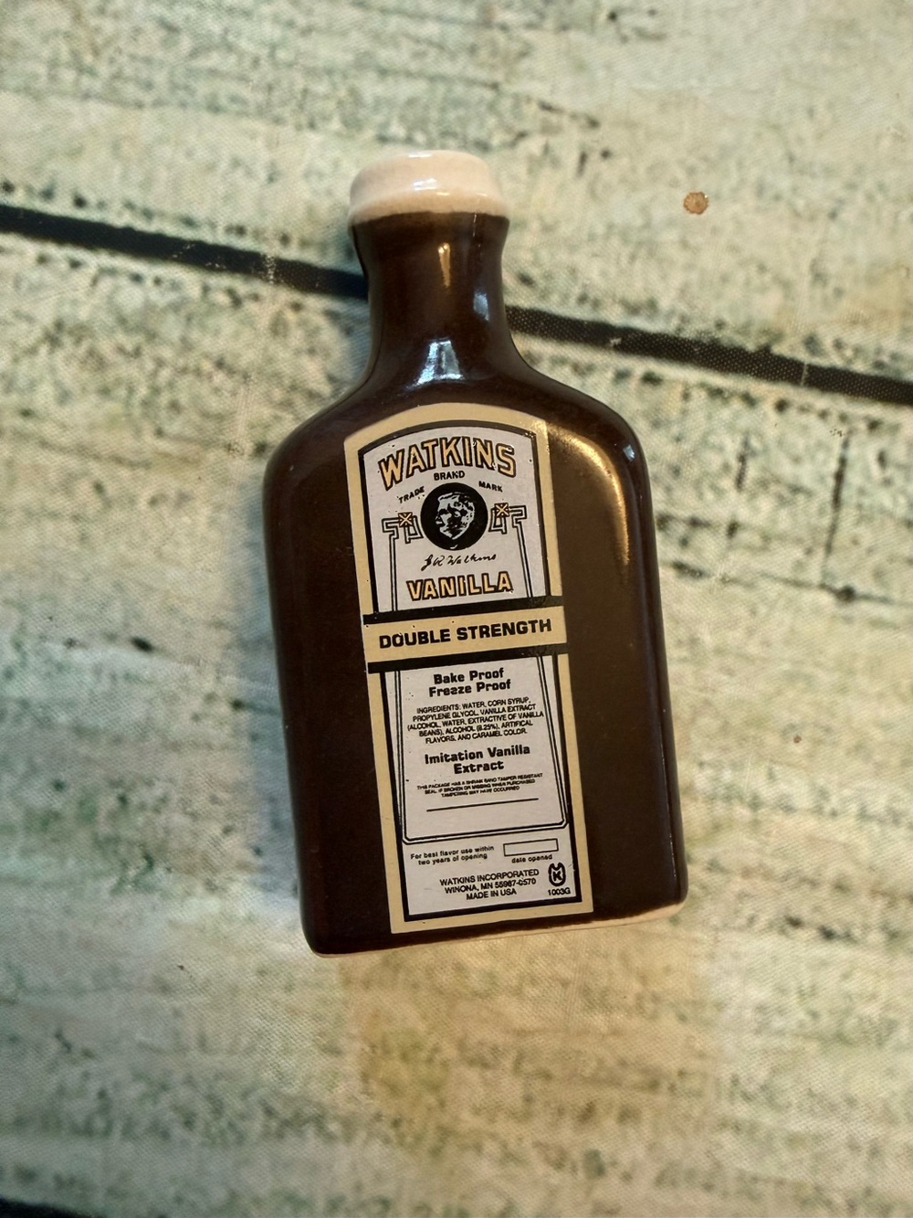 Watkins ceramic shaker mimics the brand's iconic vintage bottle.